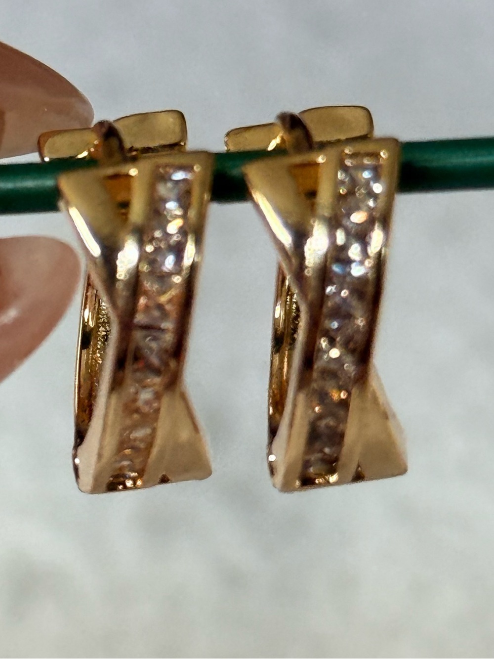 Gold Tone Twisted Hoop Earrings with Clear Stones
